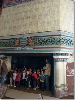 Schoolchildren inside fireplace in chambers