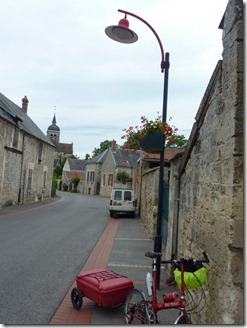 Red decorative lamp post in small village